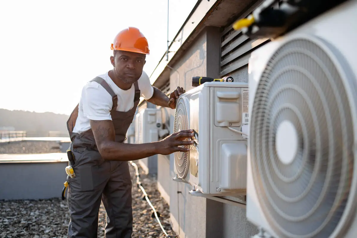 african-man-in-uniform-checking-air-conditioner-on-2023-12-21-22-00-43-utc_1200x800_1_1_optimized