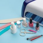 manicure-nail-polishes-uv-lamp-various-accessories-tools-manicure-trendy-blue-background_262193-1887