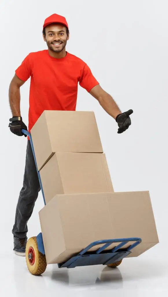 A man moving several moving carts.