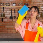 young-girl-is-wearing-yellow-gloves-while-cleaning-kichen-room-with-duster-her-house_1150-21778