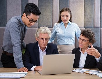 serious-business-team-watching-laptop-presentation