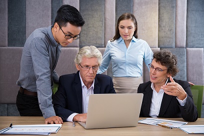 serious-business-team-watching-laptop-presentation